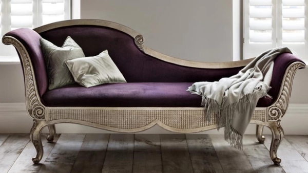 A luxurious purple velvet chaise longue with a silver leafed wooden frame in Dubai
